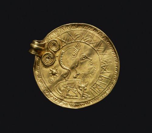 artofthedarkages: A gold pendant medal with a runic inscription and repoussé decoration depic