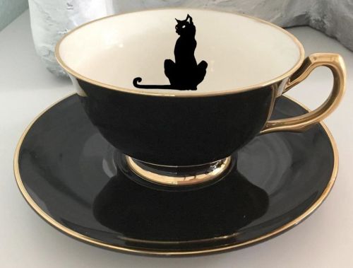 spaceshipsandpurpledrank:thefabulousweirdtrotters:Black &amp; Gold Bat/Cat/Crow/Eye Tea Set Get it h