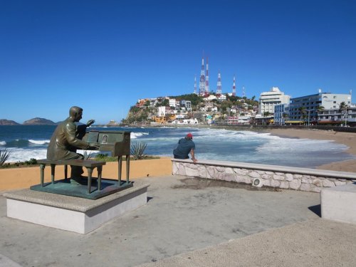 southpacifictravel: A statue of Mexican composer Fernando Valadés faces Playa Olas Altas in Mazatla