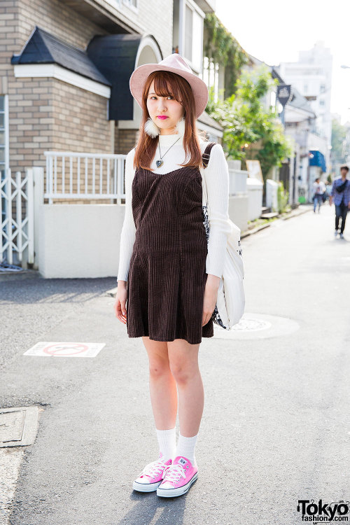19-year-old Nopi on the street in Harajuku wearing a resale corduroy pinafore with a hat, pompom ear