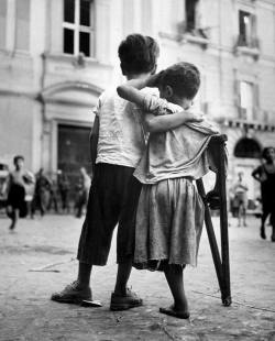 coolhistoricalphotos:  Boy helping friend with one leg, the victim of War, crossing the street in Naples in 1944. 