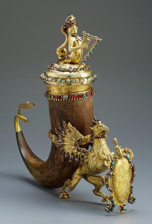 blondebrainpower:Bison horn drinking horn, silver-gilt with precious stones, and covered with figures of a griffin and mermaid. From Brno, Northern Germany, c. 1630.