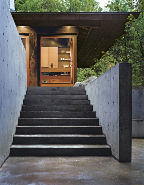 archatlas:    Tye River Cabin Olson KundigSituated in a dense forest near the Tye River, this meditative retreat connects to the nature that surrounds it.The square base of the two-level structure is rendered in cast-in-place concrete, as is the large