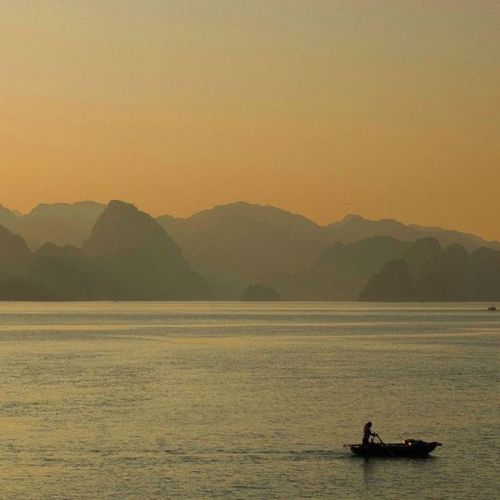 Sun setting over Ha Long Bay, Vietnam. A UNESCO World Heritage Site and one of the top attractions i