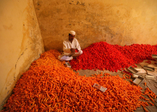 Inmate Ramesh Kumar packs candles in boxes after making them for the Hindu festival of Diwali, insid