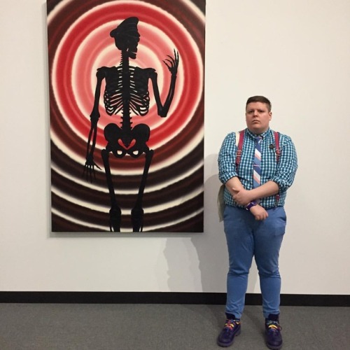 This is me with the artwork of Roger Brown at ART AIDS AMERICA being forever pissed off at the exclu