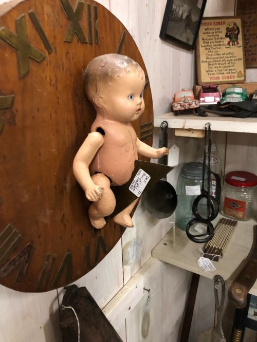 shiftythrifting:Some VERY haunted dolls in an antique shop in vermont -WHY IS THE BABY IN A BOTTLE I