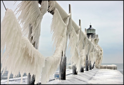 odditiesoflife:  Frozen Pier at Lake Michigan Located on Lake Michigan is the century old St. Joseph North Pier. When the wind moves across the pier during Michigan’s freezing winter months, large waves crashing upon the pier and lighthouses literally