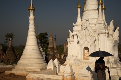 unrar:  A woman walks past one of the Shwe Inn Thein, a set of 1054 stupas near the
