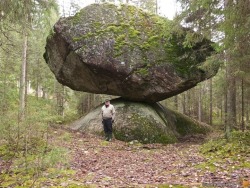 oldcitystreets:  unexplained-events:  Kummakivi or “Strange Rock” can be found in the forests of Finland. These strange geological formation have, without any scientific explanation, wound up in a perplexing positions. The mystifying sight is that
