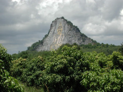 kelledia:  This cliff in Chonburi, south of Pattaya, Thailand, has a Buddha figure engraved in it, 130m tall and 70m wide and is inlaid with gold.  It can be seen from miles away.