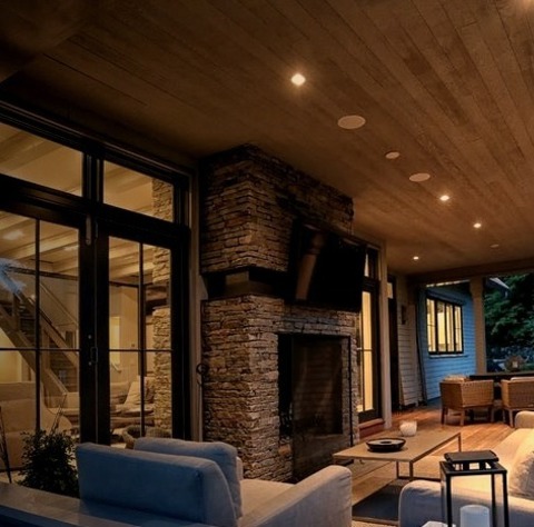 Backyard In New YorkAn Example Of A Mid-sized Modern Back Porch Design With A Fire Pit And A Roof Extension.