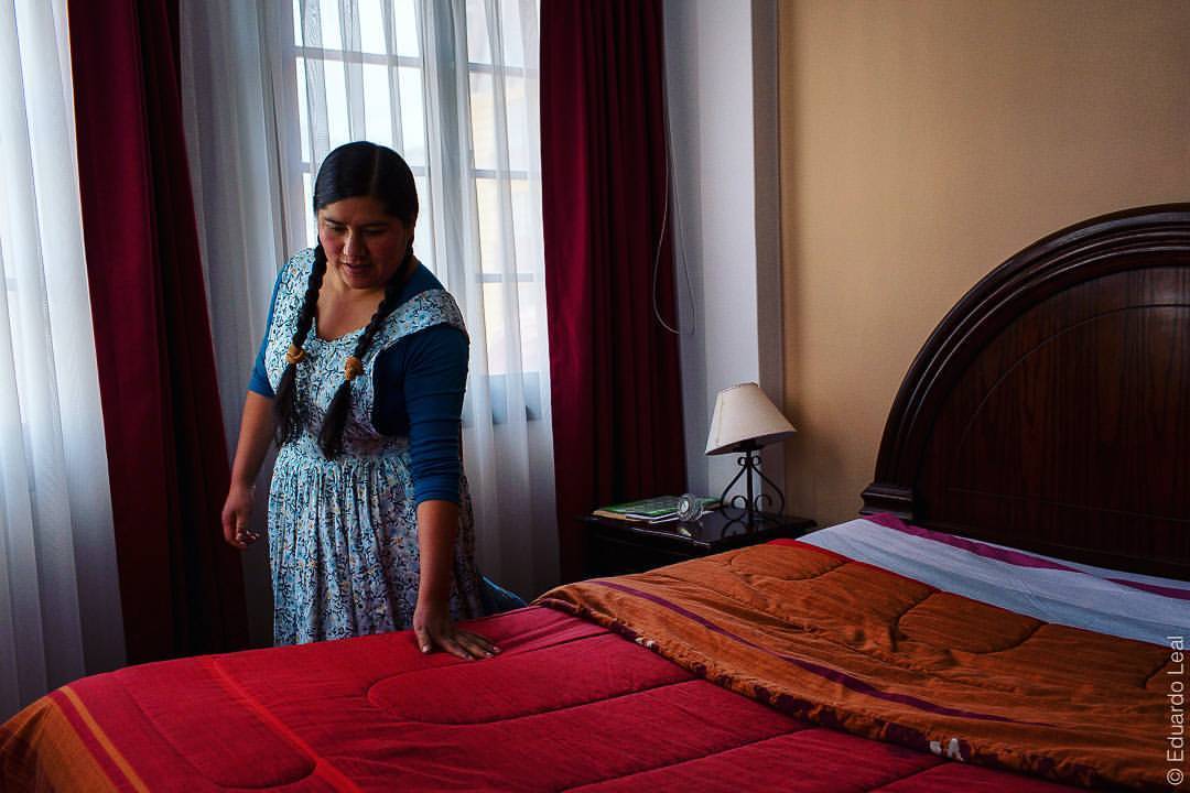 Celia Ramos checks out the room of her boss after a general clean up. She has been working in this house since she was 14 years old. She says that her bosses gave her a life that otherwise she will never have but still she dreams for more...