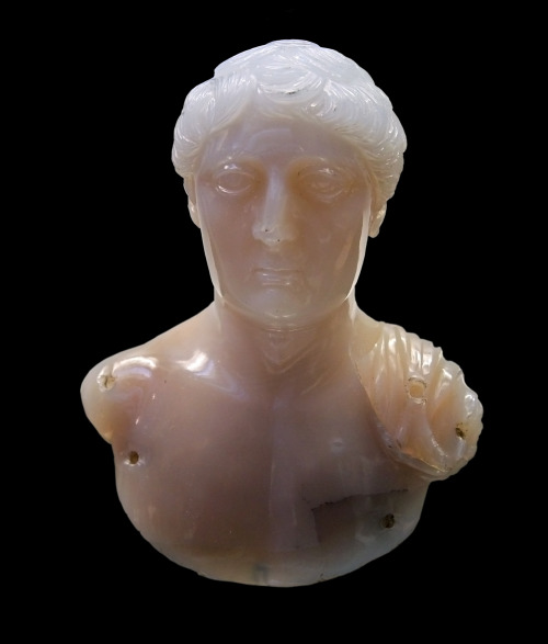 Ancient Roman chalcedonyappliqué depicting the bust of a young man in a cloak.  Artist unknown; ca. 