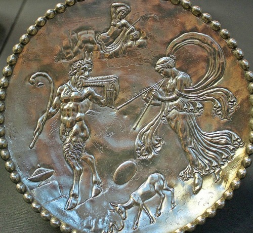 aquilasaurus:pansgrotto:The silver dish shows a Maenad, female follower of Bacchus, dancing and blow