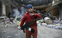 kinghispaniola:  letswakeupworld:  Eight-year-old Ahmed, one of the youngest fighters in the Syrian Civil War, smokes a cigarette and holds an AK-47 while patrolling a blockade in Aleppo.  He is the son of a rebel fighter, and now follows his uncle,