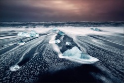 sixpenceee:  Photographers from all over the world flock to Jökulsárlón Beach in south-eastern Iceland to capture the beautiful icebergs that wash ashore. Floated into the sea from a nearby glacial lagoon, the turquoise colored icebergs are a stunning