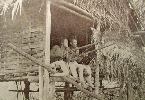 Two Phlippine Moros with Spanish Rolling Block rifles, Philippine Wars, early 20th century.