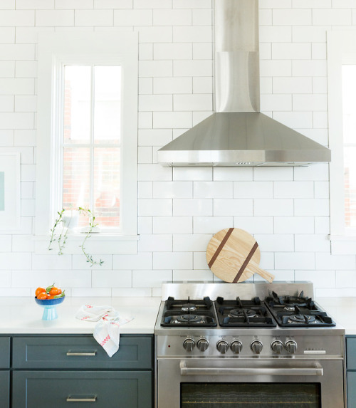 White subway tile kitchen area with stainless steel range hood. Photo & Styling: Leslee Mitchell