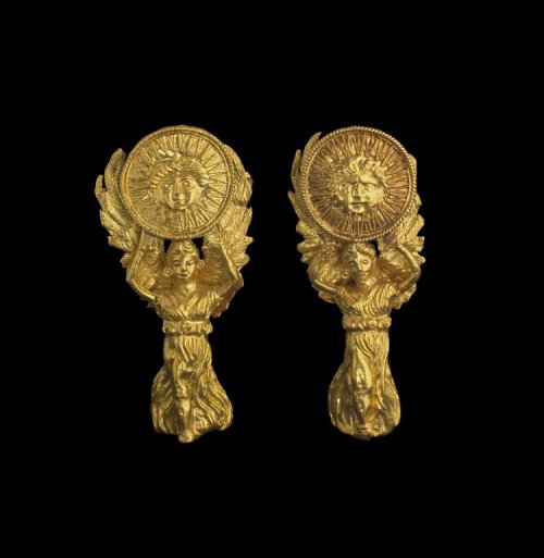 ancientpeoples:Pair of Earrings depicting Nike holding up a solar disk on which the sun god Helios i