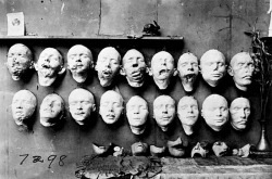 Masks used to create facial prosthetics. Top row casts were taken of soldiers&rsquo; mutilated faces; the bottom row shows masks of their faces before their injuries that were made from pre-war photographs. On the table are masks made to fit over the