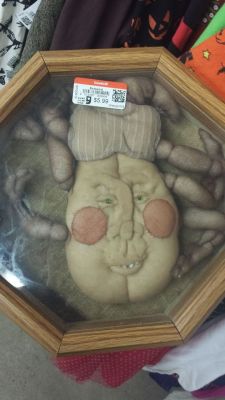 shiftythrifting:  I’ve had this saved since I found it two years ago in the Halloween decor. There was a hand sewing needle rattling around inside the frame so I have to conclude that someone MADE this. Spent their hard earned time and effort to give
