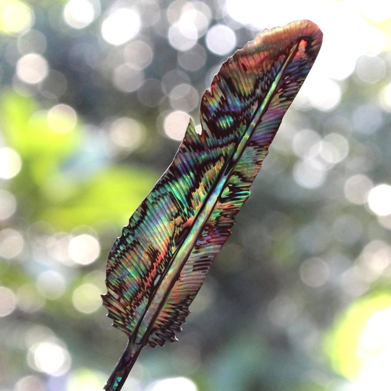 coolthingoftheday:  A feather carved from an abalone shell. 