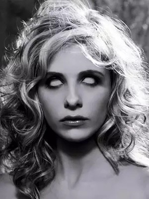 black and white portrait of sarah michelle gellar with white glowing eyes and dramatic lighting.