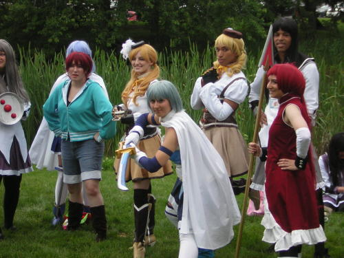 righthandminion:  Madoka Magica photoshoot at AnimeNEXT  Ahhh yay!  More pictures of us! The Sayaka farthest right that’s bent in an action pose is appledress, the Kyoko next to her is meeeee, and the tall Homura behind us is funkypriest.