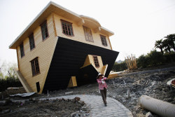 sixpenceee:    A labourer works at an upside-down house under construction at Fengjing Ancient Town, Jinshan District, south of Shanghai, March 17.  Source:   Carlos Barria / Reuters &amp; BuzzFeed