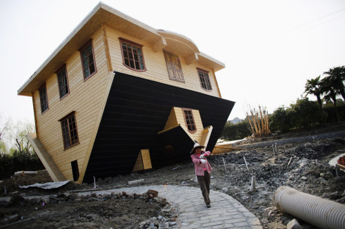 sixpenceee:    A labourer works at an upside-down house under construction at Fengjing Ancient Town, Jinshan District, south of Shanghai, March 17.  Source:   Carlos Barria / Reuters & BuzzFeed