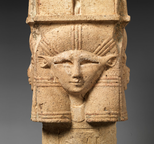 Ancient Egyptian column capital (limestone) in the shape of the head of the goddess Hathor.  The col