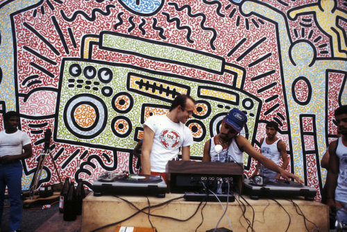 twixnmix:    Keith Haring at his P.S. 97 mural in New York City, 1985.  Photos by