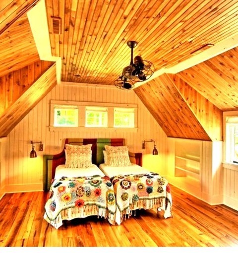 Minneapolis BedroomLarge Mountain Style Loft-style Medium Tone Wood Floor Bedroom Photo With Beige Walls