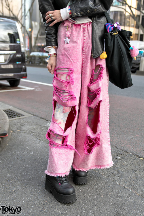 Sakura Pluto on the street in Harajuku wearing a biker jacket over Bubbles tee, ripped pink Candy St