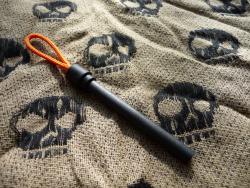 ru-titley-knives:  A 6mm diameter firesteel epoxied into one half of a safety break away cord lock with type 1 vest cord loop . Wrapped in natural jute cordage which can then be waxed for long term storage  aprox 80 cms worth of cordage .  Heat shrink