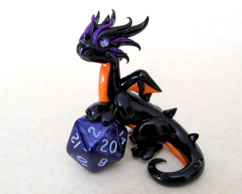 thehappysorceress:archiemcphee:What better creature to protect your precious d20 dice than adorably 