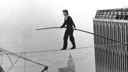 historicaltimes: Philippe Petit walk on a wire between the roofs of the Twin Towers of the World Trade Center, a quarter mile above the ground. August 6, 1974. via reddit 