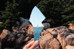 sixpenceee:In this creative capture by Casey Coulter, we see a sailboat just off the coast of Maine reflected in a broken piece of mirror.