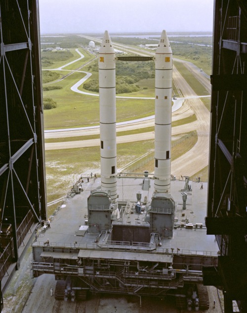 Twin Solid Rocket Boosters rolling their stately way into the VAB in preparation for mating with STS-1. I can’t fathom how many hours it took for the crawler to get all the way over there. Also, that doesn’t look even more precarious than a...