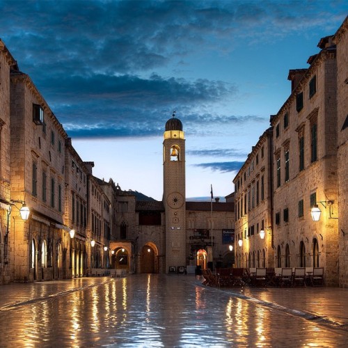 Early in the morning, the polished marble streets of Dubrovnik reflect beautiful color and light.—