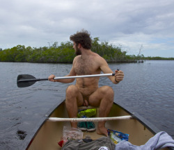 grover3:  The Man is rowing nude into the Wild Fag Nature Reserve in the nude so  as not to spook the wild fags in their natural habitat.  Being nude like  the wild fags allows him  to approach closely for observation without  frightening them away.