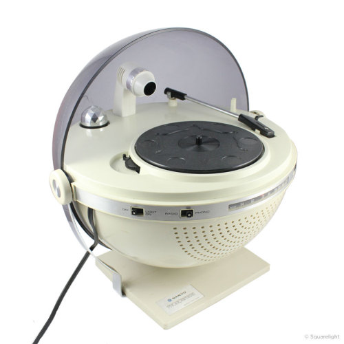 White background. Image of a white, spherical record player without a vinyl in place. A small mirror ball and light are featured in the back center of the base.