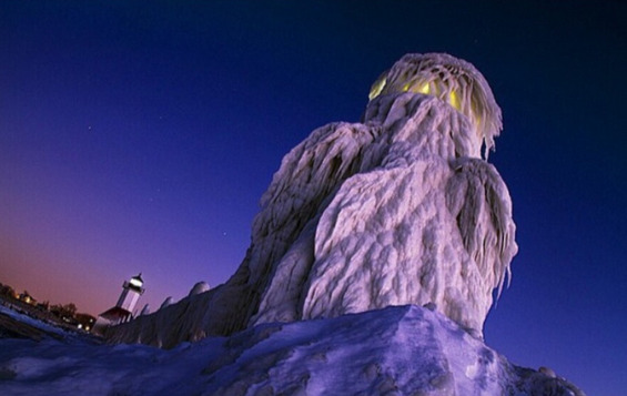 sixpenceee:  An ice covered lighthouse on Lake Michigan 