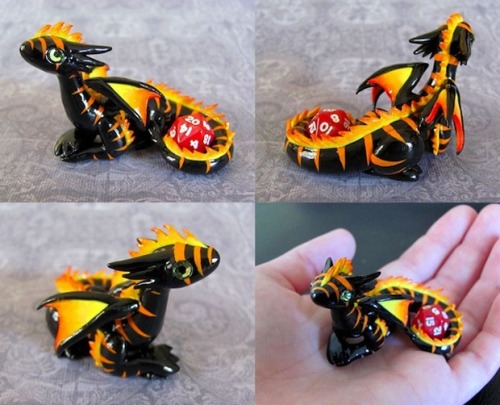 thehappysorceress:archiemcphee:What better creature to protect your precious d20 dice than adorably 