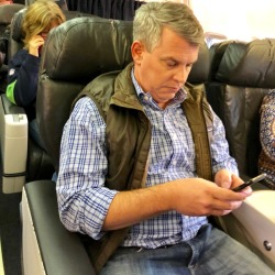 daddiesonthego:  Casual Vest First Class Daddy pretending to be engaged in some important matters on his phone so he does not have acknowledge the pedestrians on their way back to their cattle class seats.