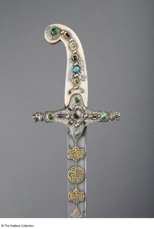 Ornate sabre decorated with gold, silver, ivory, and colored gems. Blade was produced in 16th centur