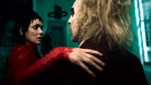 Beetlejuice And Lydia Blowing Kisses At Each Other