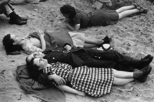 A soldier, on leave from his wartime duties, lying on the beach with his girlfriend at the Lancashir