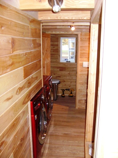 tinyhouseamerica:  Another AMAZING tiny house!  This home is built on a standard trailer and uses the galley floor plan to fit in full sized washer and dryer (the shiny red boxes), full sized kitchen appliances, and a bathroom with an incinerating toilet!